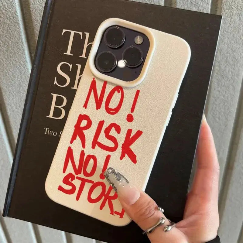 Phone case in cream with red NO! RISK NO! STOP slogan; shockproof bumper for iPhone.
