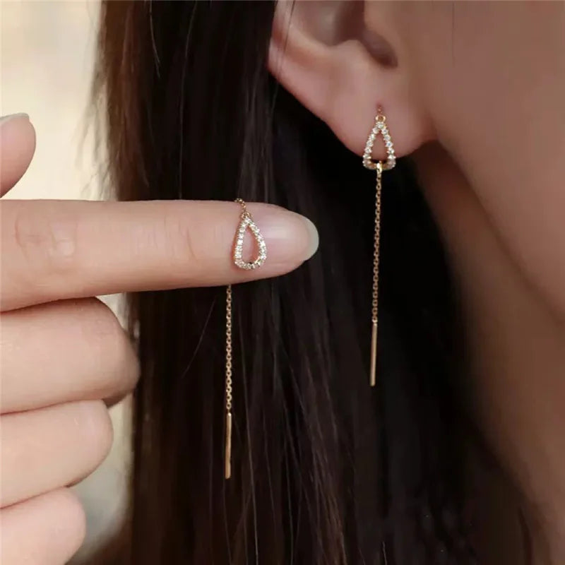 Simples Market long teardrop drop earrings with crystal-studded outline and gold-tone chain pair