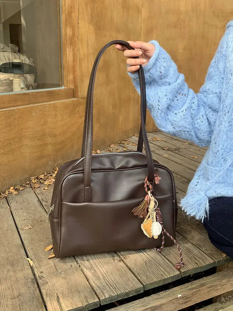 Simples Market brown leather tote bag with large capacity, long double handles and shell tassel charm