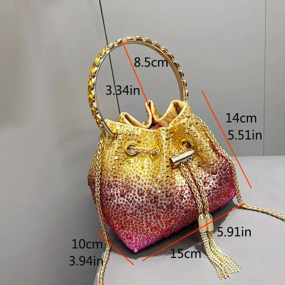 Rhinestone evening clutch bag with gradient gold-to-pink crystals, crystal-studded circular handle and gold chain tassel
