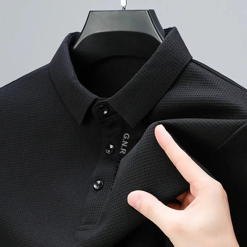 Men's waffle-knit polo shirt in black with button placket on hanger