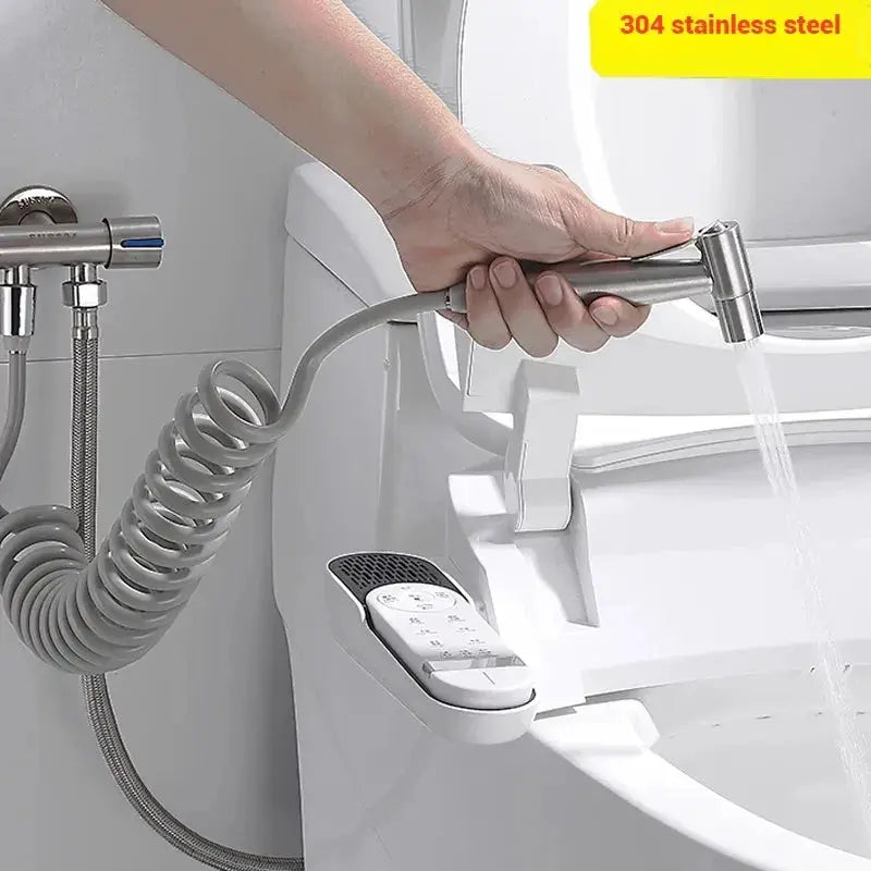 Simples Market handheld bidet spray nozzle, 304 stainless steel with coiled hose, near a toilet.