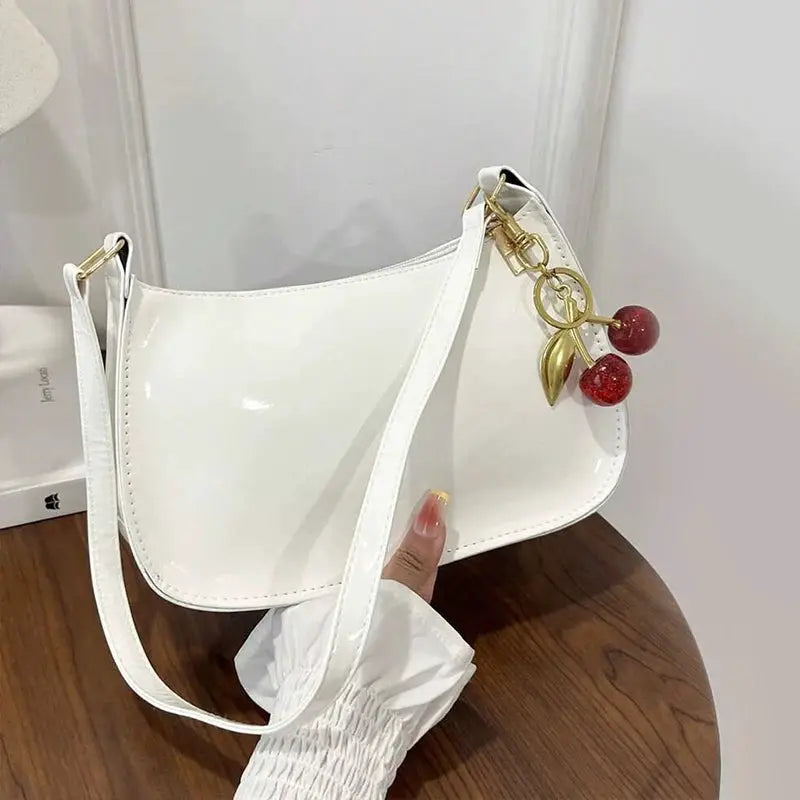 Women's glossy white PU leather shoulder bag with cherry pendant charm