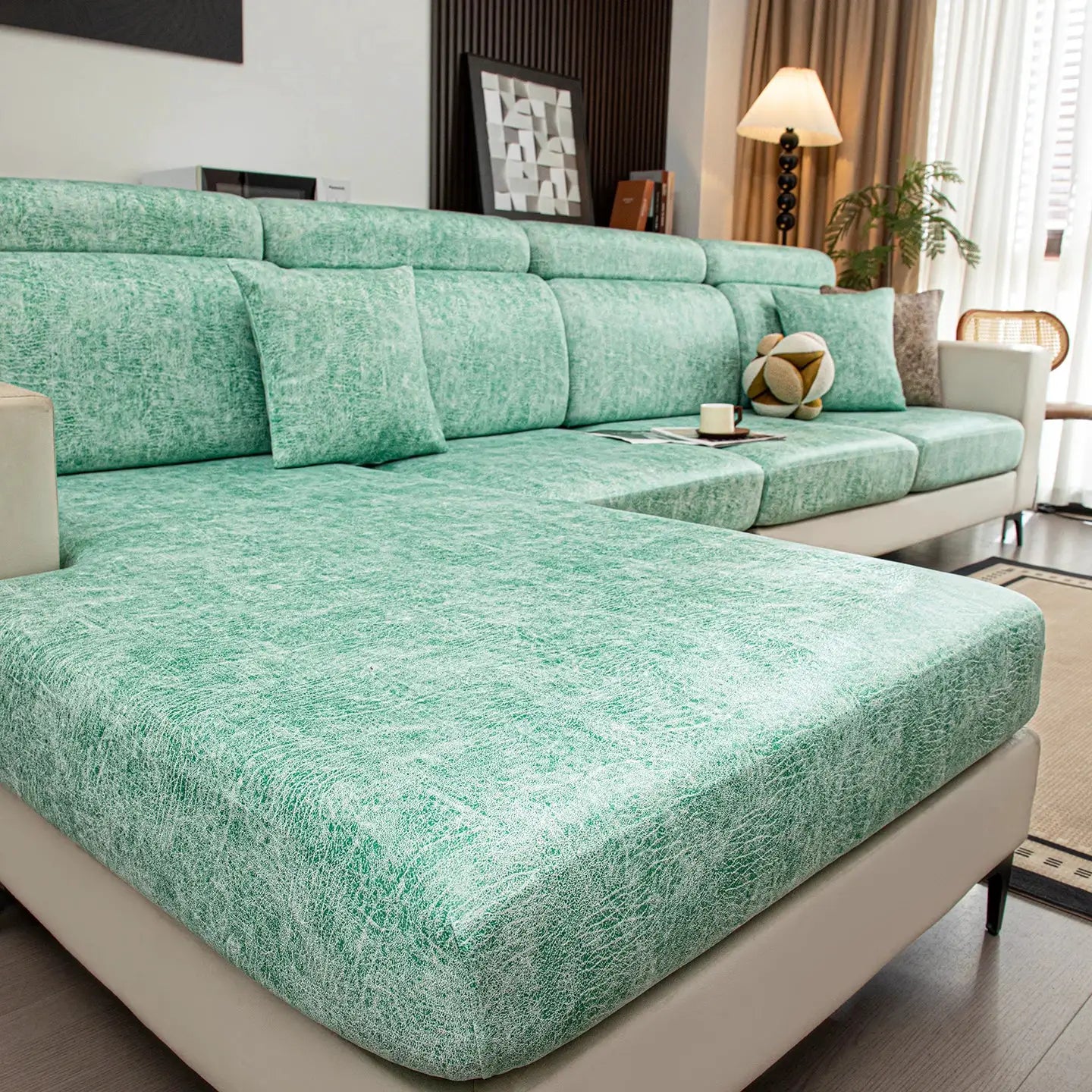 Simples Market stretch sofa cover in teal atop a large sectional with multiple cushions