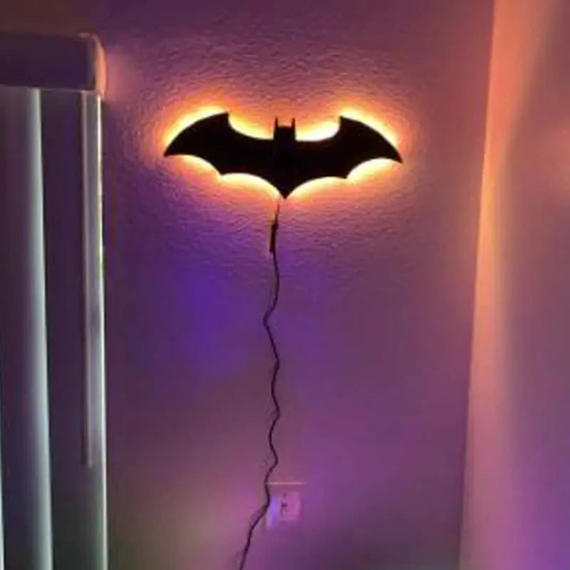Wooden bat-shaped wall lamp with warm LED backlight and corded power for bedroom or living room.