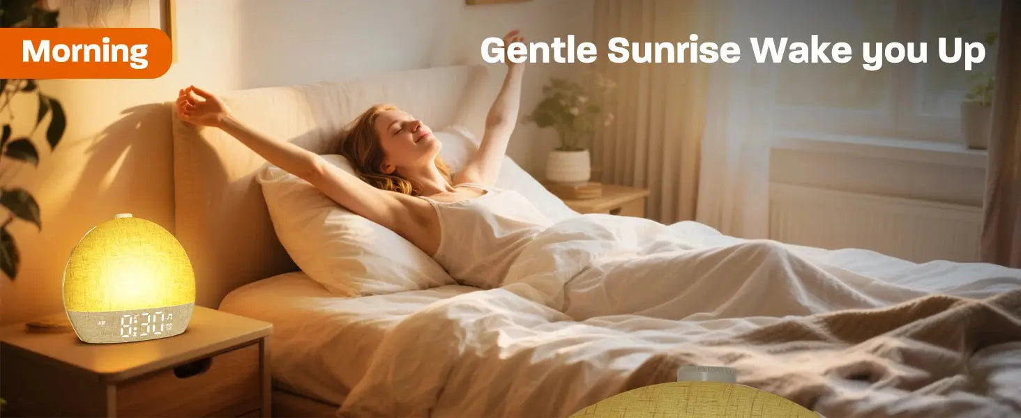 Simples Market wake-up light sunrise alarm clock on bedside table with two warm lamps; woman waking up in bed.