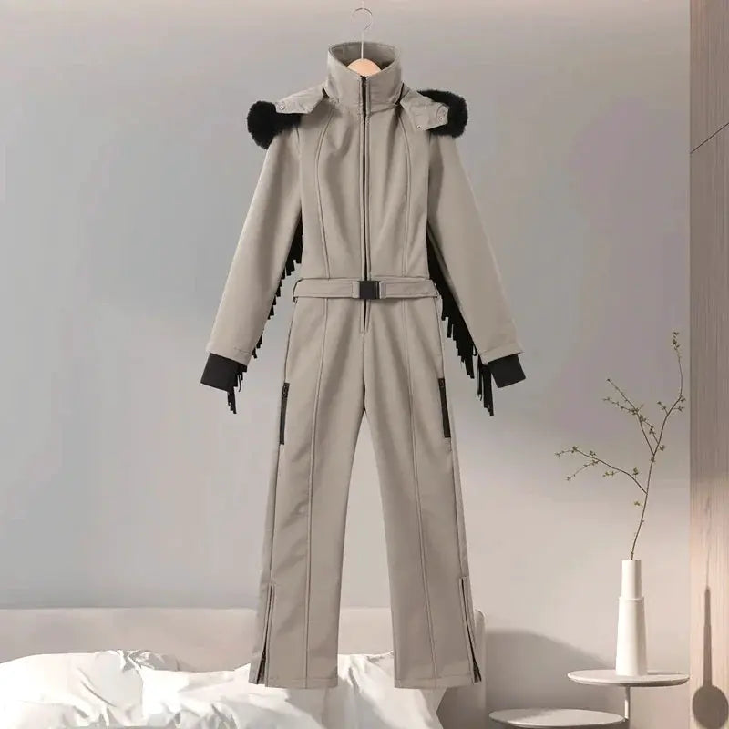 Simples Market beige women’s one-piece ski suit with faux-fur hood, belt and tassels