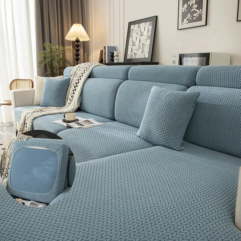 Sofa cover set in blue knitted elastic fabric with matching ottoman cover for living room.
