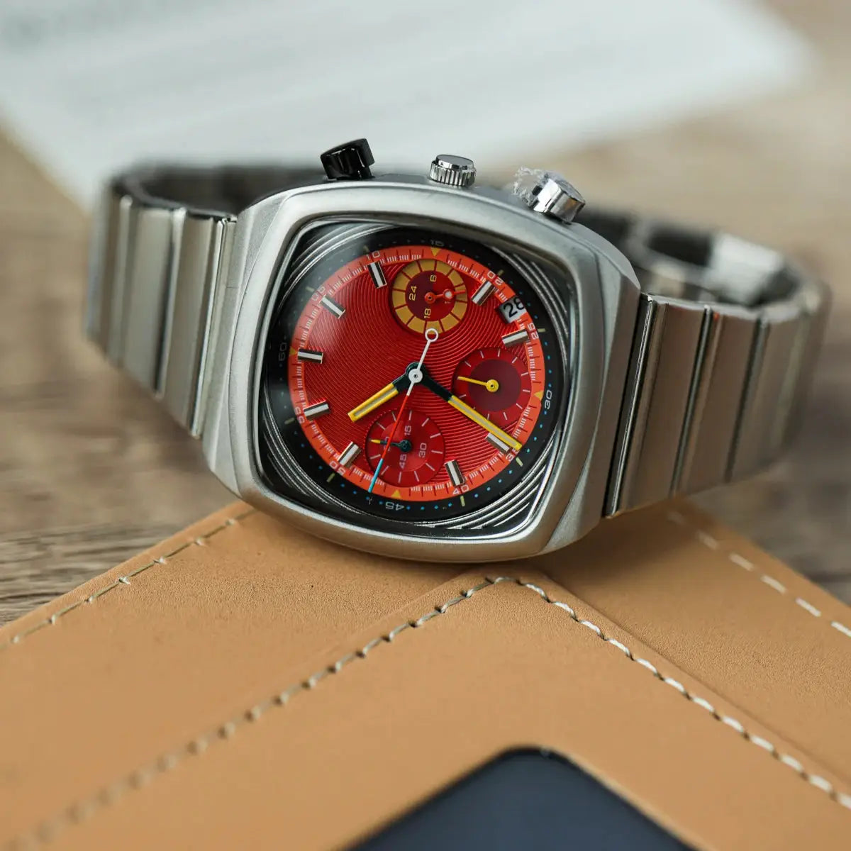 CILOA square men's watch with red chronograph dial, yellow accents, and stainless steel case and bracelet