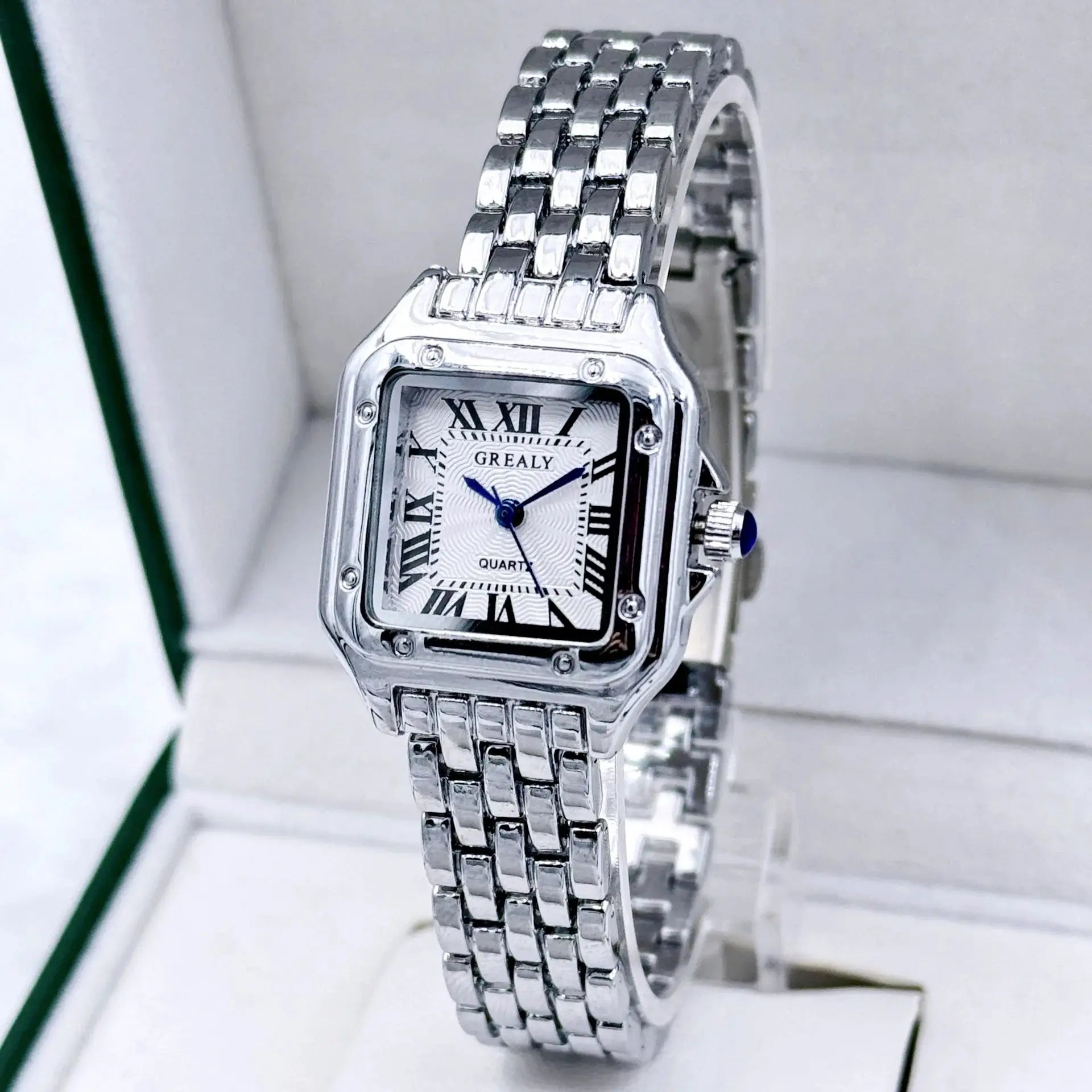 Ladies stainless steel bracelet watch with rectangular silver case, Roman numeral dial, blue hands.