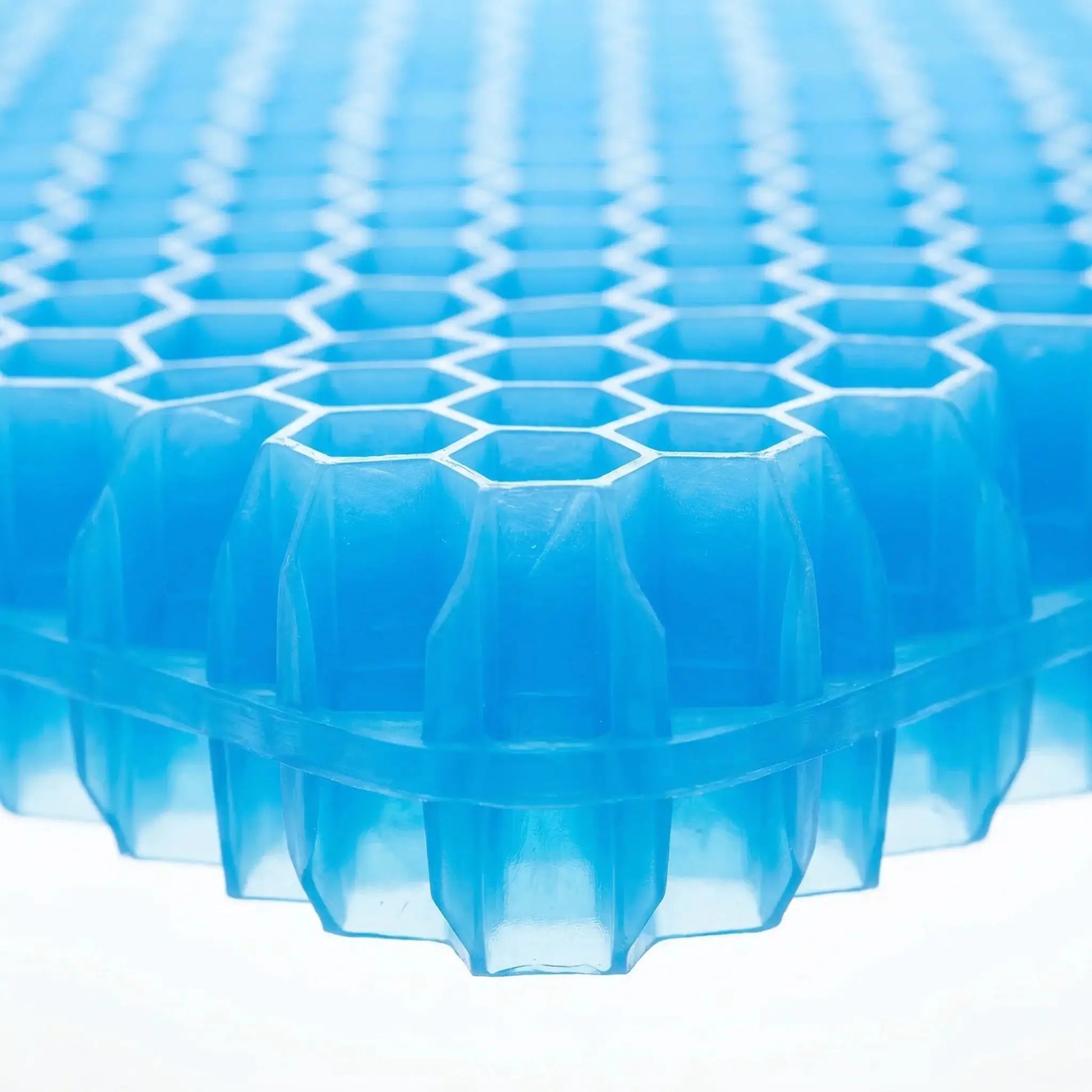 Blue honeycomb-patterned plastic grid with hexagonal openings and stacked panels