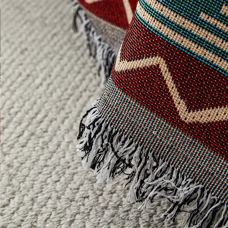 Sofa cover blanket by Simples Market, ethnic geometric pattern in red, teal and beige with fringe