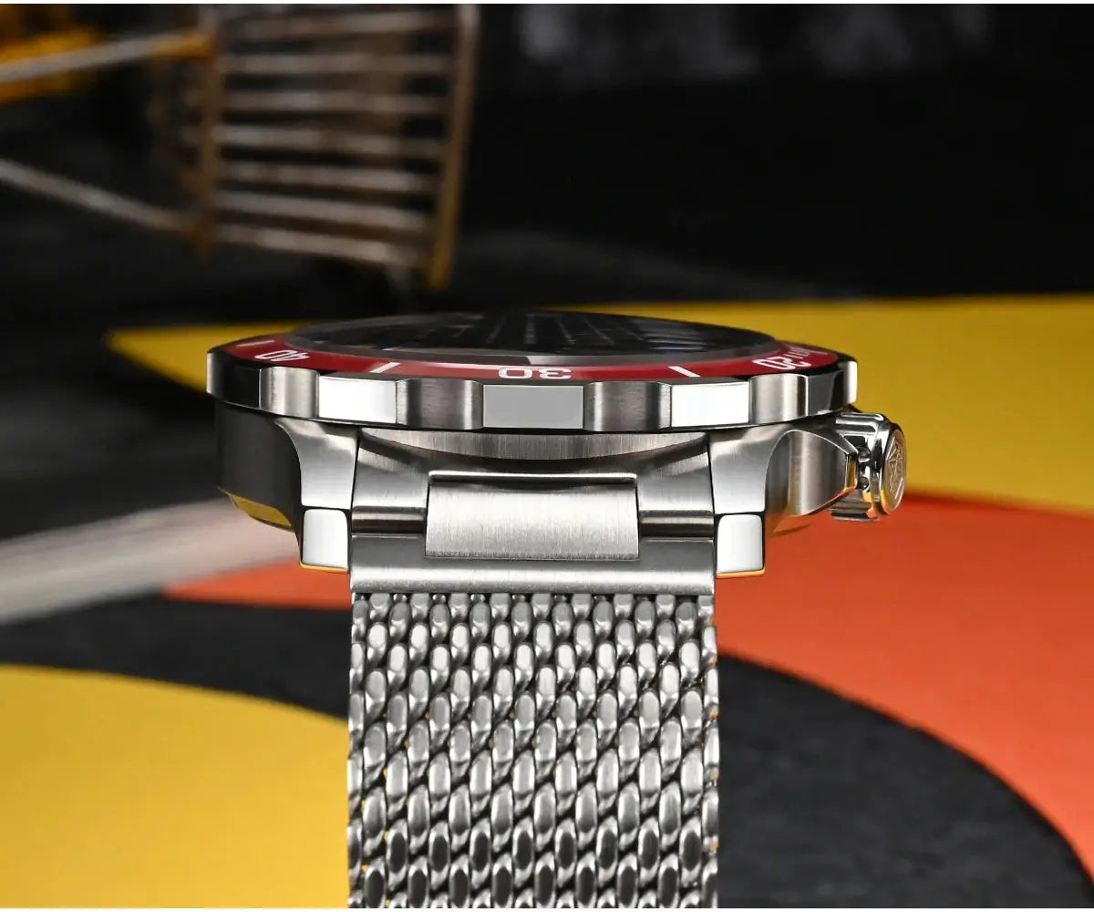 San Martin diver watch with red bezel and stainless steel case on a Milanese mesh bracelet