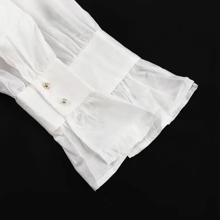 White long-sleeve shirt cuff with two buttons and flare sleeve detail
