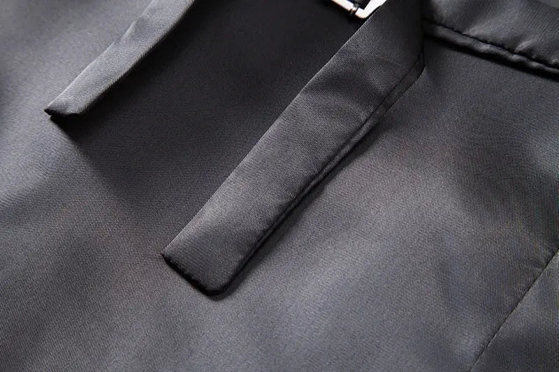Men's gray waistcoat with lapel; smooth fabric close-up.