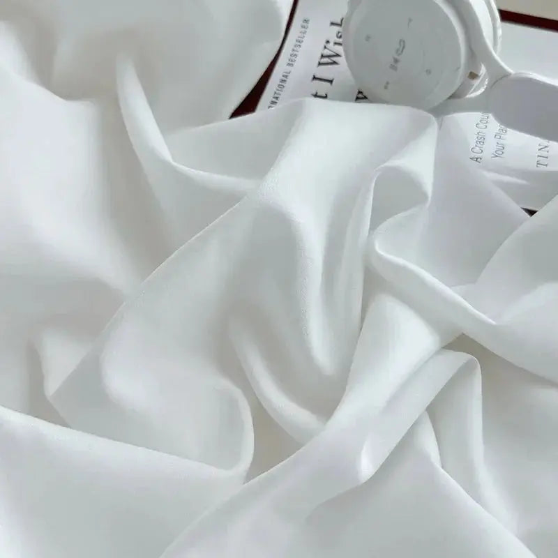 Washed white fitted sheet with elastic corners; non-slip adjustable mattress cover for single to king beds.
