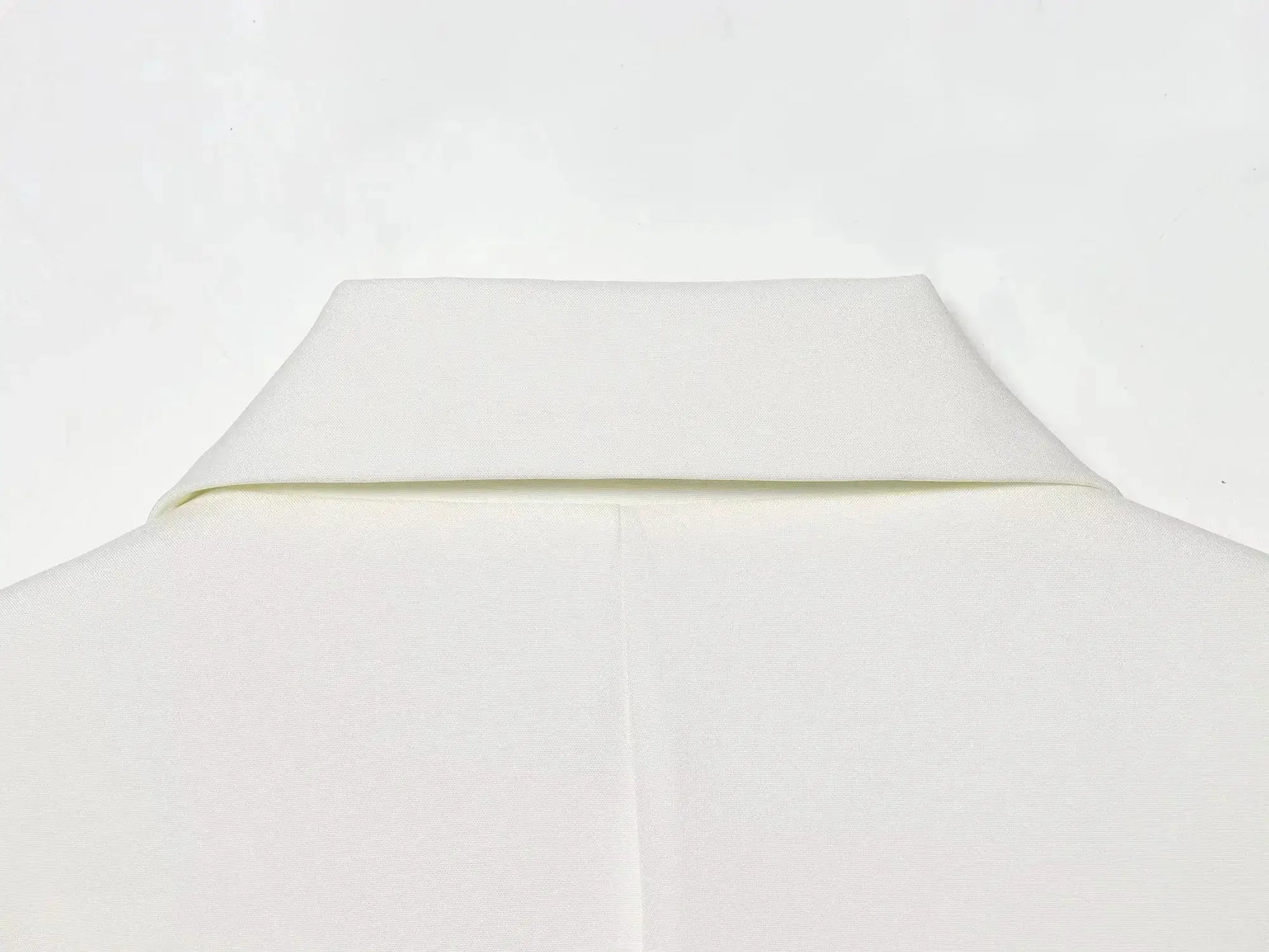 KONDALA white blazer fabric close-up showing textured solid material and seam detail
