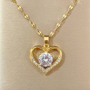Gold-tone heart pendant necklace with a central clear gem and pavé crystals on the heart outline