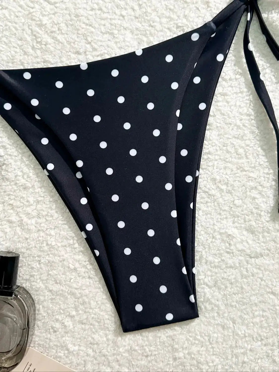 Bikini bottom from Simples Market, navy blue with white polka dots and side ties