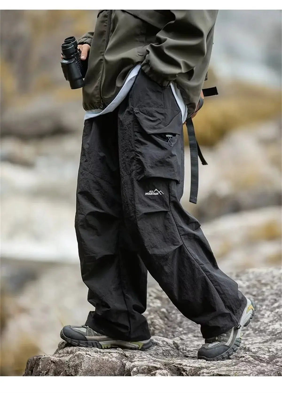 Men's waterproof mountaineering cargo pants in black with multiple pockets
