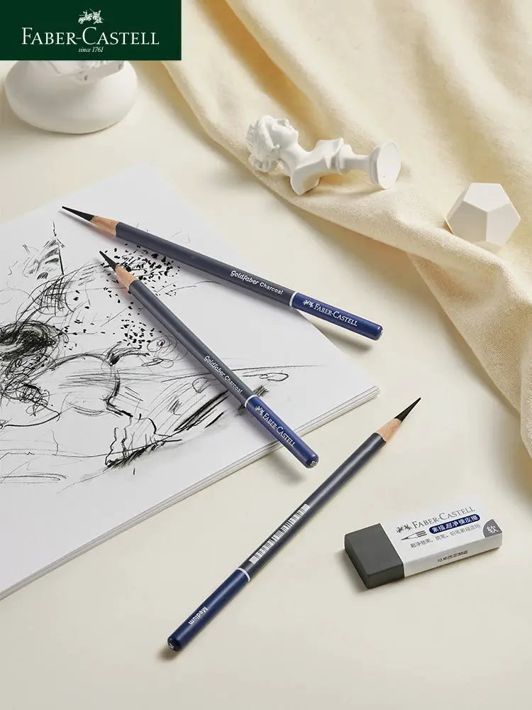 Faber-Castell Goldfaber 5/6-piece charcoal and graphite sketch pencil set with blue barrels on a sketchbook