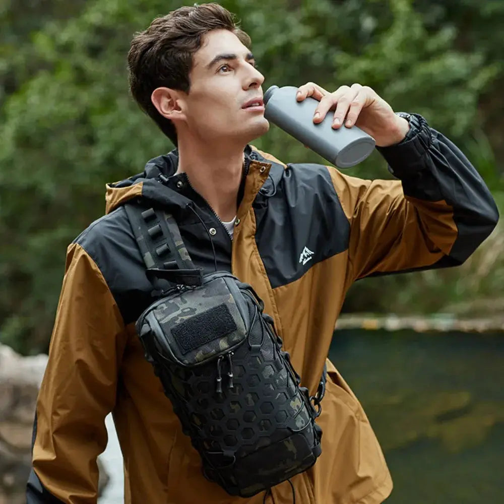 Tactical sling backpack with camo hex mesh exterior and small front pouch