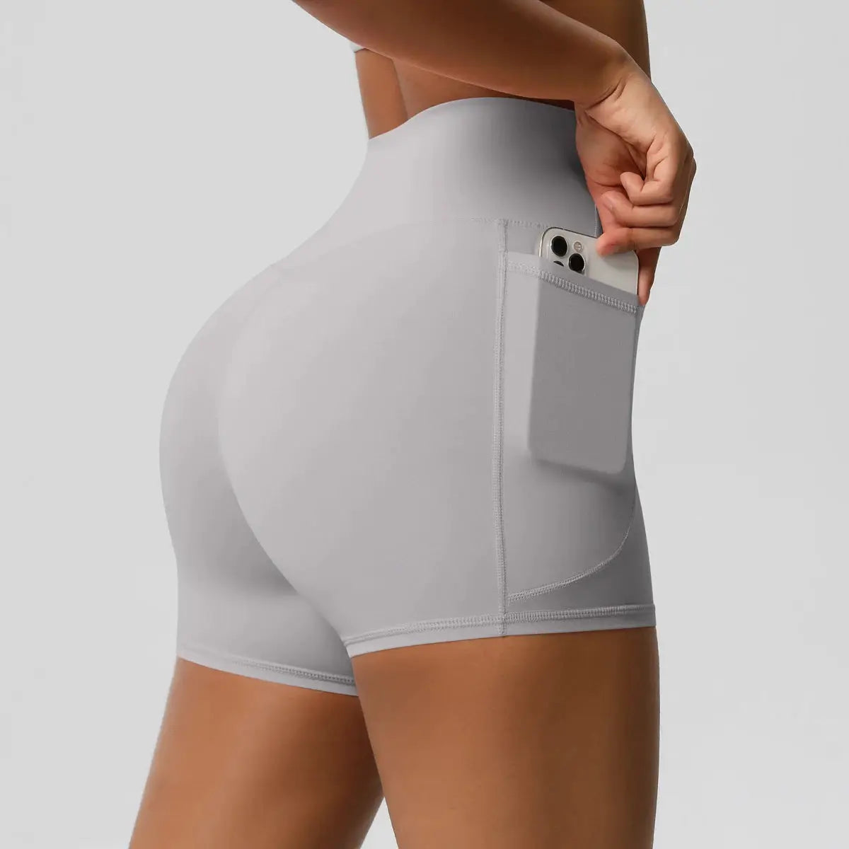 Women pocketed high-waist yoga shorts in light gray with side phone pocket