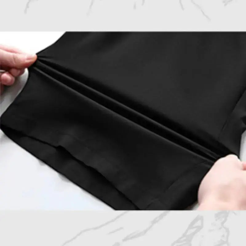 Men's black oversize shorts fabric stretched to show elasticity and smooth texture