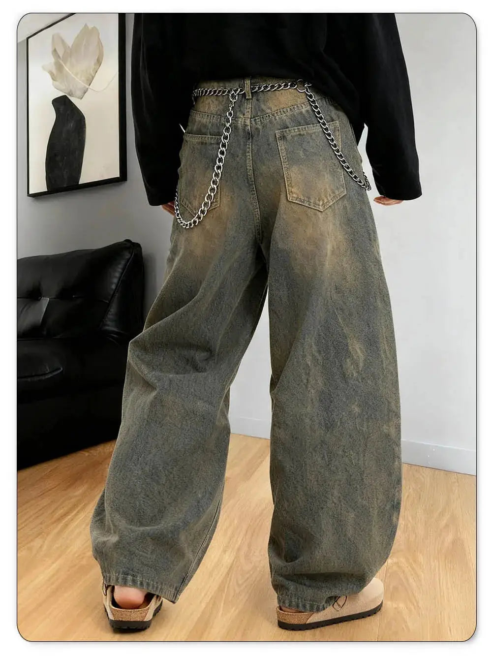 Baggy wide-leg denim jeans in washed gray with distressing and silver chain belt back view