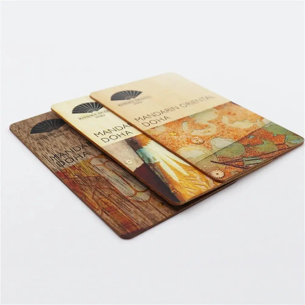Three wooden NFC laser cards with 13.56MHz RFID tags, NTAG-style chips, featuring brown wood grain and prints.