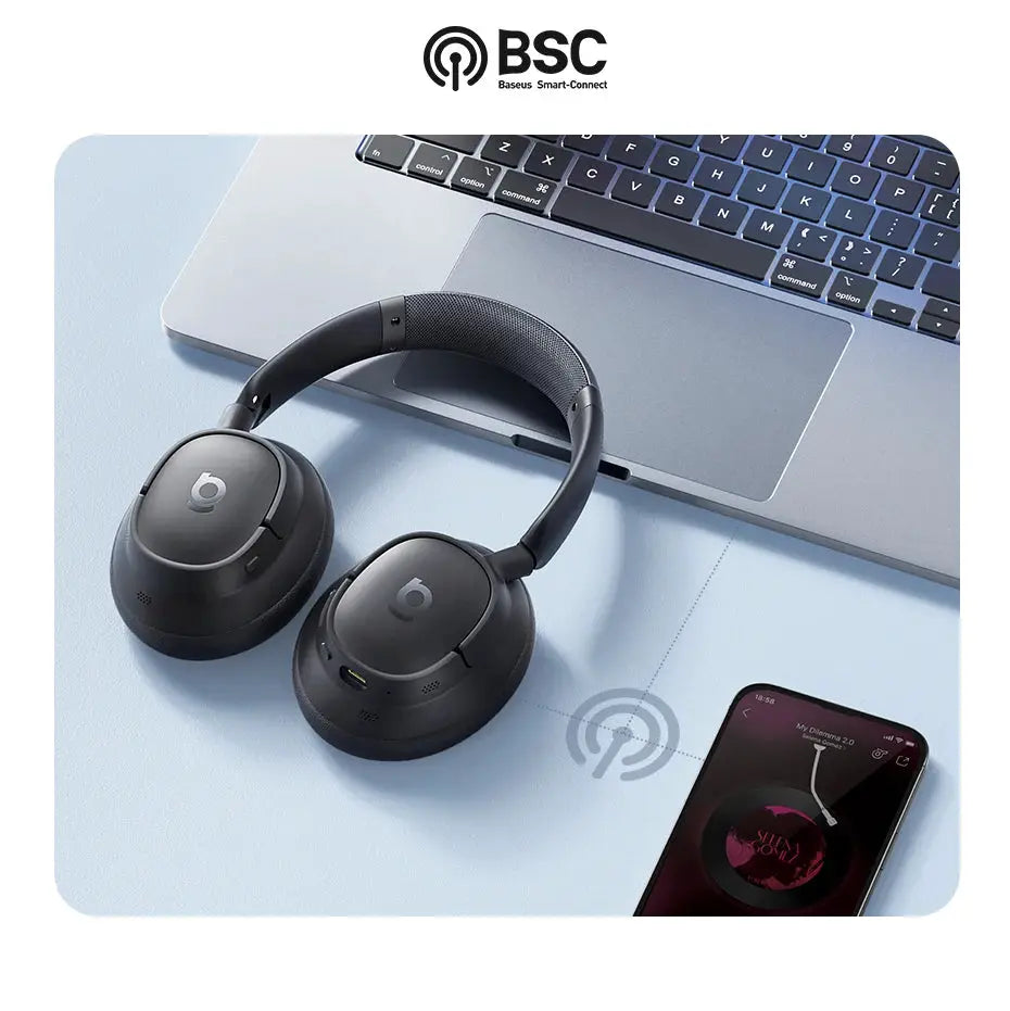 Baseus EH10 NC ANC wireless over-ear headphones, black with logo, beside a laptop