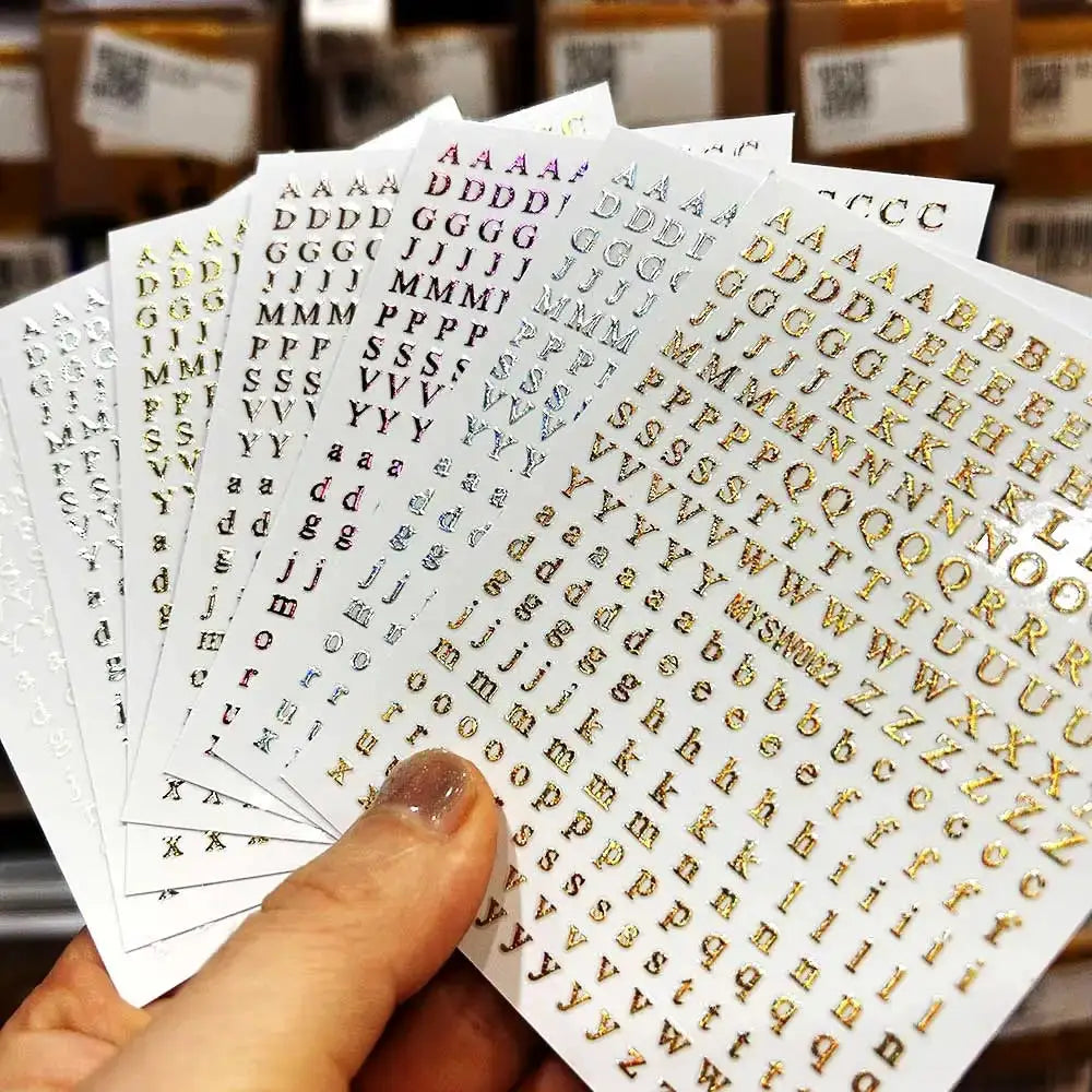 Simples Market 3D alphabet nail stickers in laser silver/gold on 8x10cm sheets; self-adhesive manicure decals