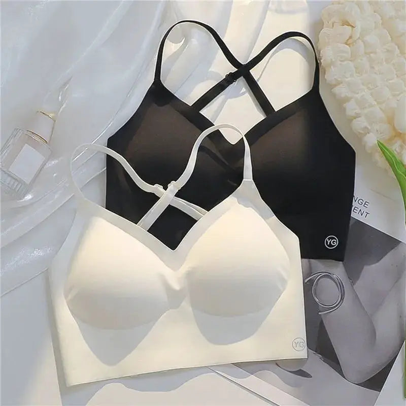 Two women invisible bras in white and black with strapless backless design and clear straps; YG logo