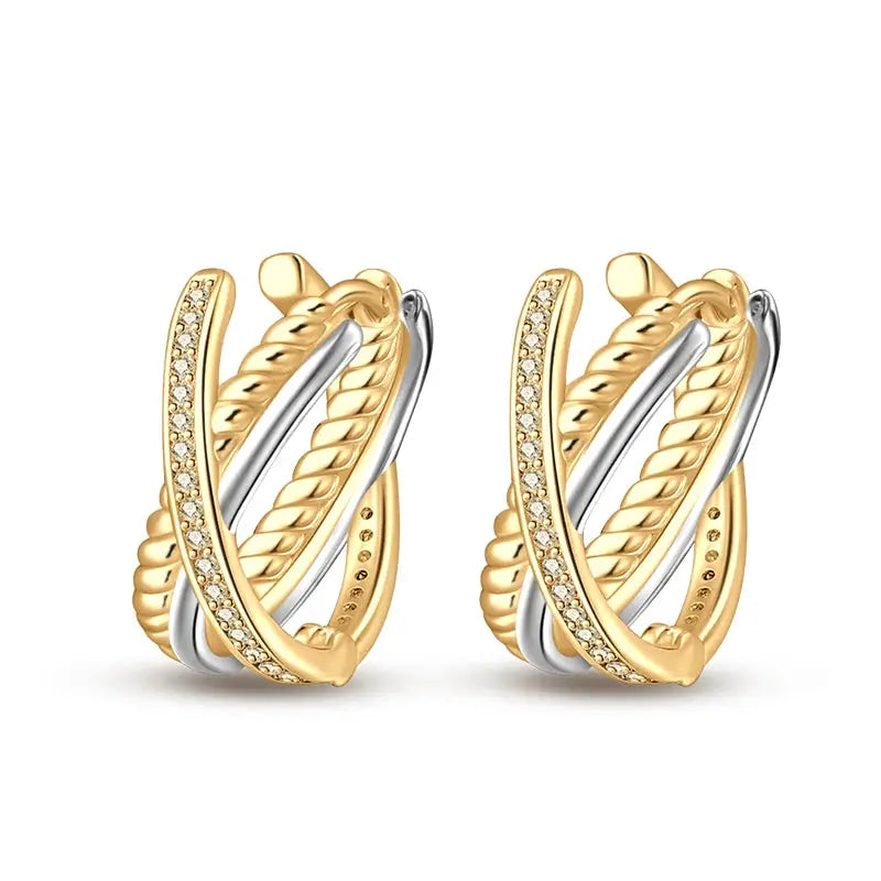 Pair of gold-tone and silver hoop earrings with crystal pave accents.