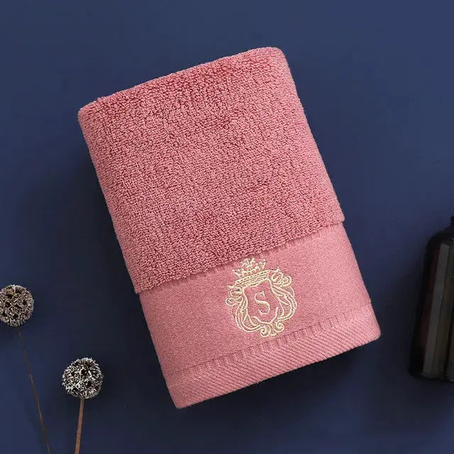 Simples Market pink cotton towel with gold crest embroidery, neatly folded for display