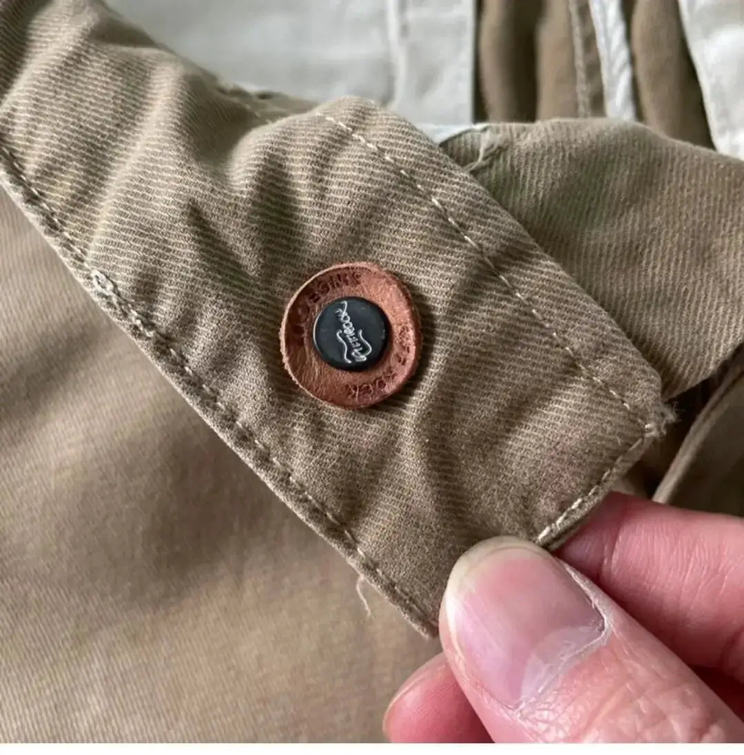 Cargo pants by Simples Market in khaki cotton with brown cuff button detail