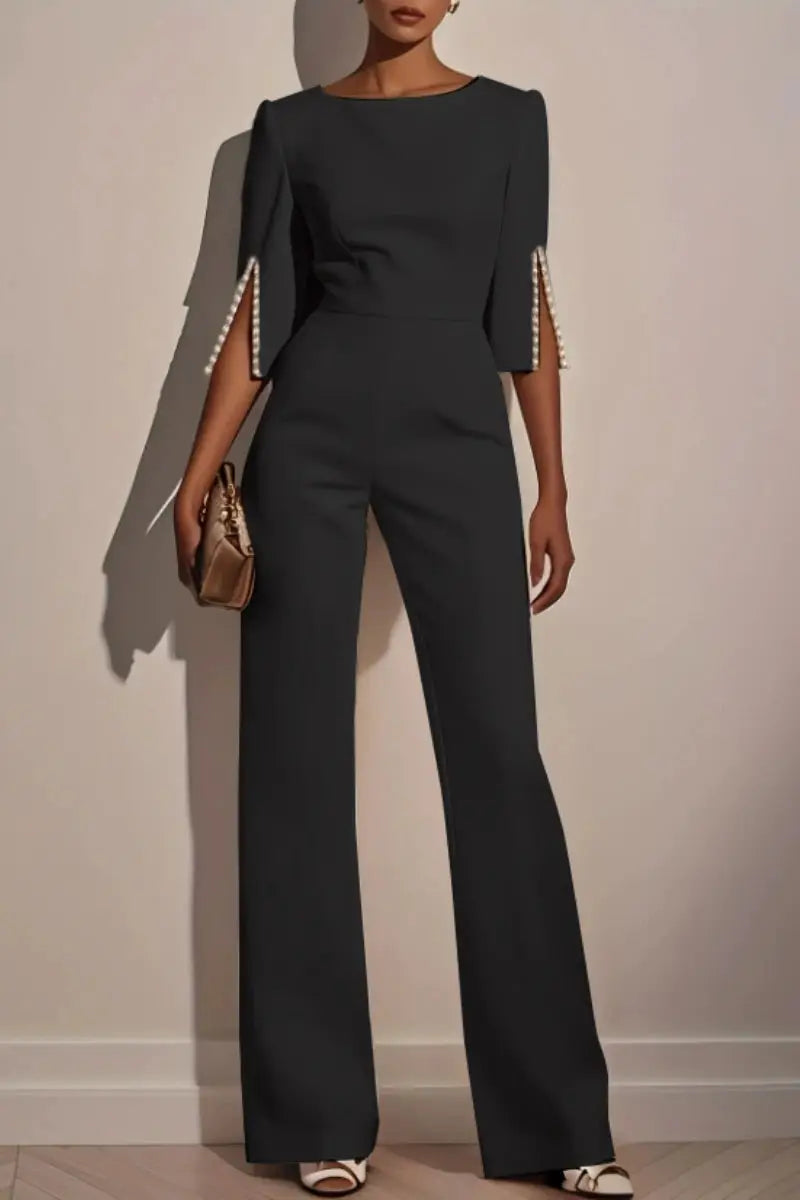 Women's black jumpsuit with pearl-trimmed 3/4 sleeves and a high-waist, wide-leg silhouette
