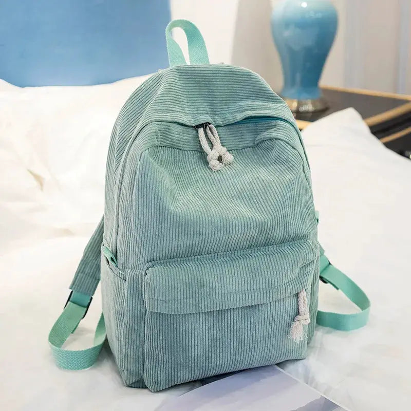 Personalized kids backpack in teal corduroy with front pocket, top handle, and mint green straps