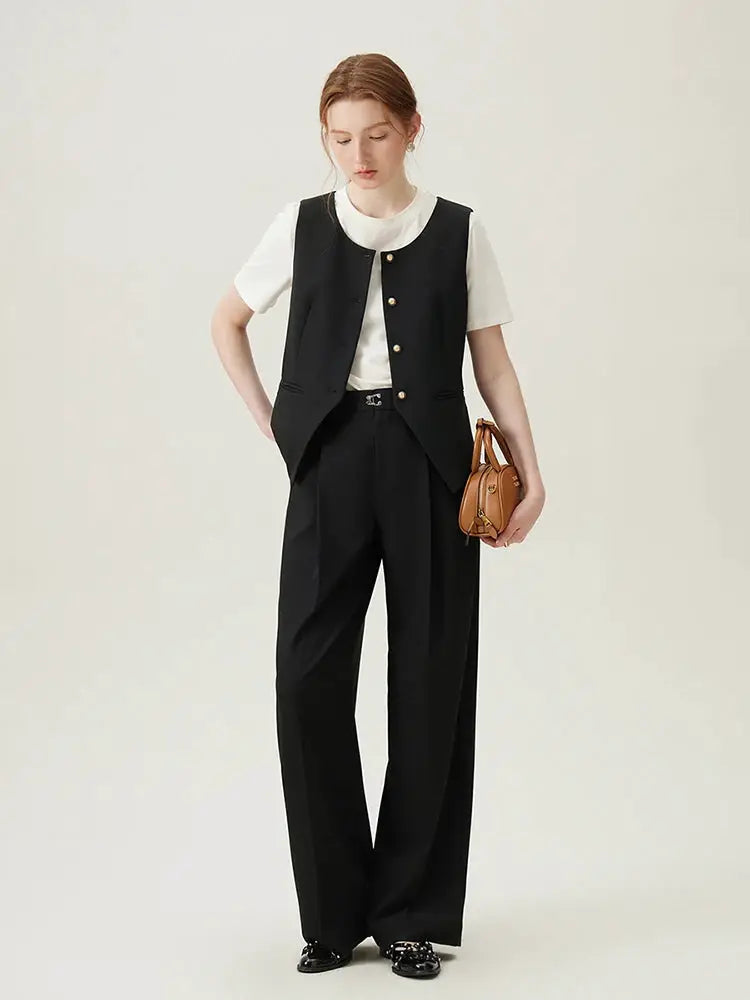 FSLE women blazer vest set in black with white top and wide-leg pants, model carrying a brown handbag