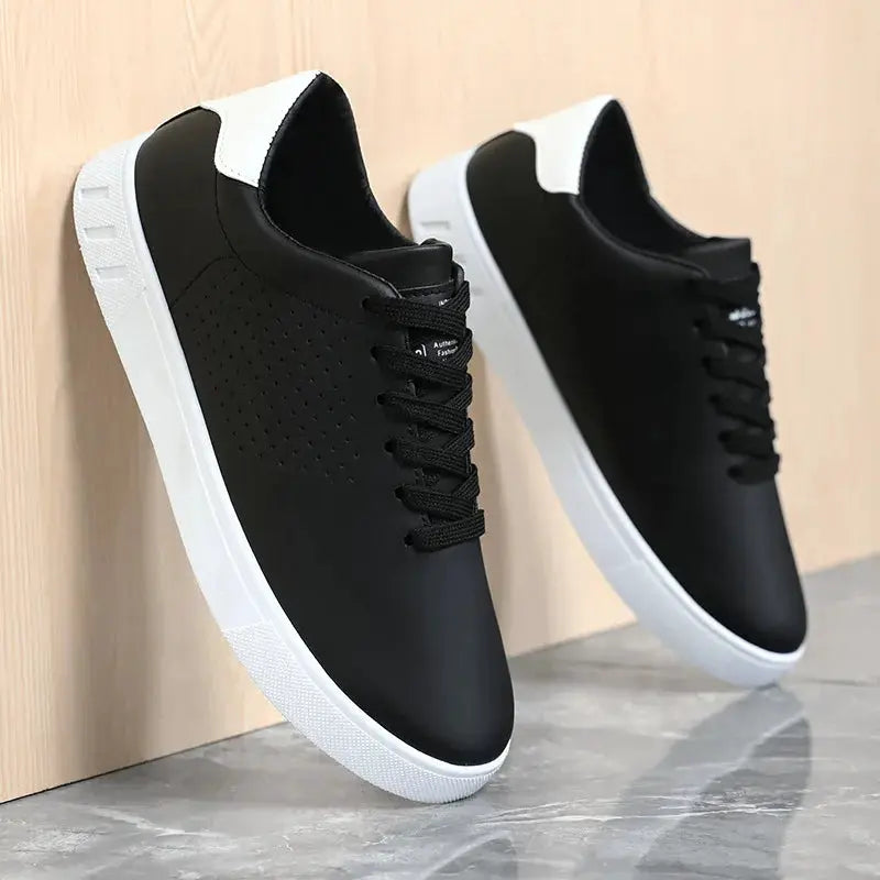 A pair of men's black leather lace-up sneakers with perforated sides and white sole by Simples Market