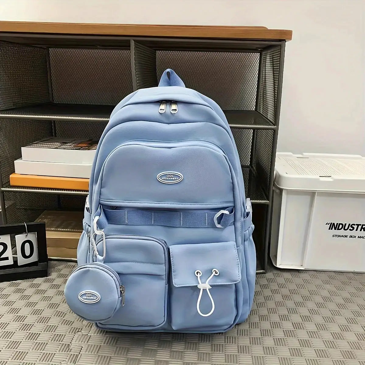Simples Market light-blue large-capacity school backpack with multiple pockets and a small round pouch.