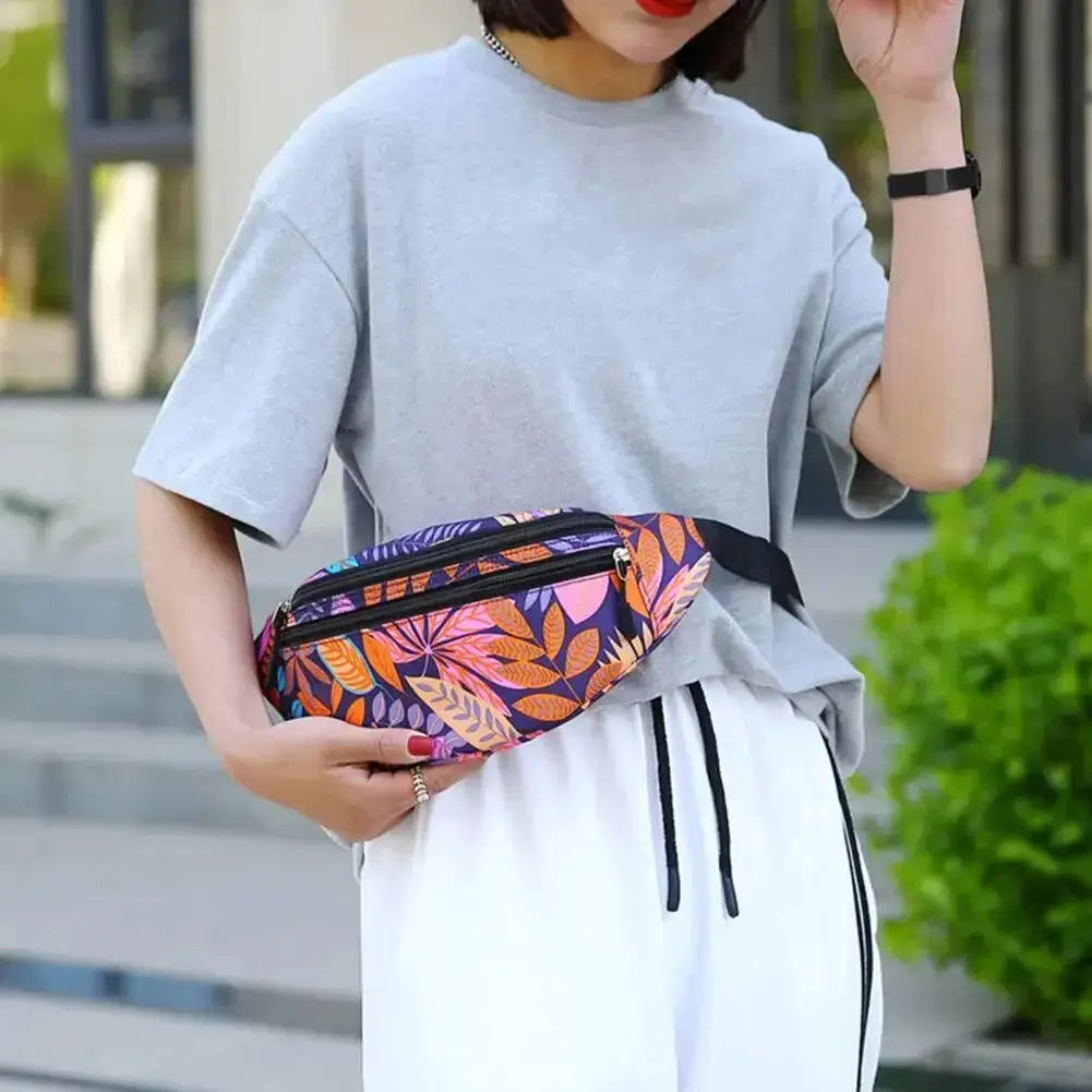 Sports waist pack with multicolor leaf print, waterproof running belt worn at the waist with phone holder.