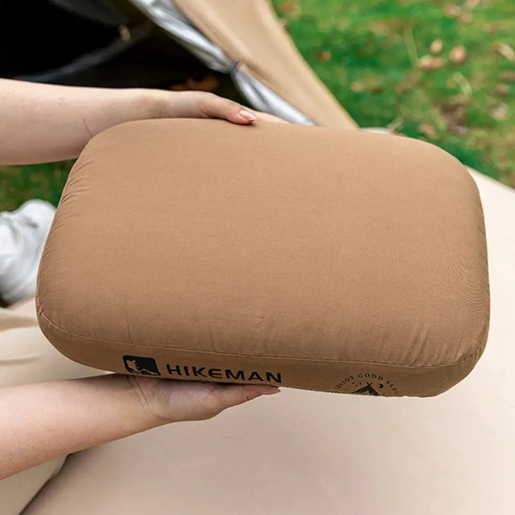 HIKEMAN memory foam neck pillow in tan for camping and travel, neck-support cushion.