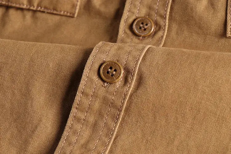 Khaki solid-color work shirt by Simples Market with brown buttons and cuff details.