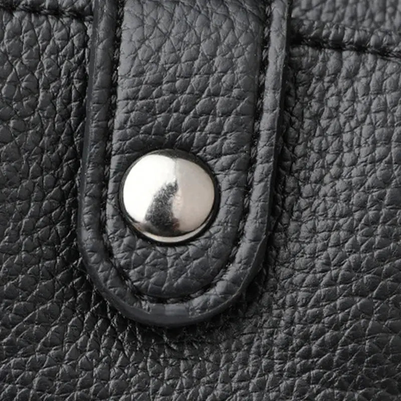 Black PU leather diagonal crossbody bag with a round metal snap.