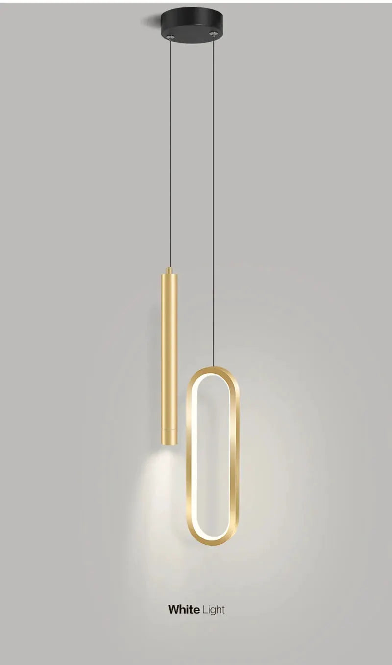 Nordic LED pendant light by Simples Market with a gold finish; vertical tube and illuminated oval loop pendant design.