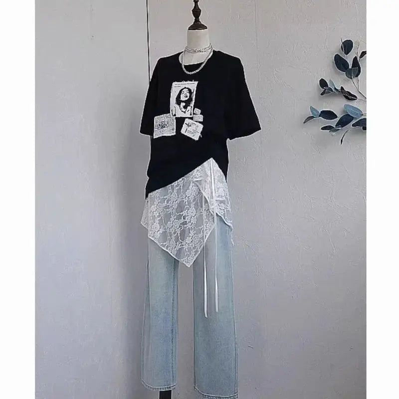 Simples Market lace wrap skirt layered over light-wash denim with a black graphic tee on mannequin