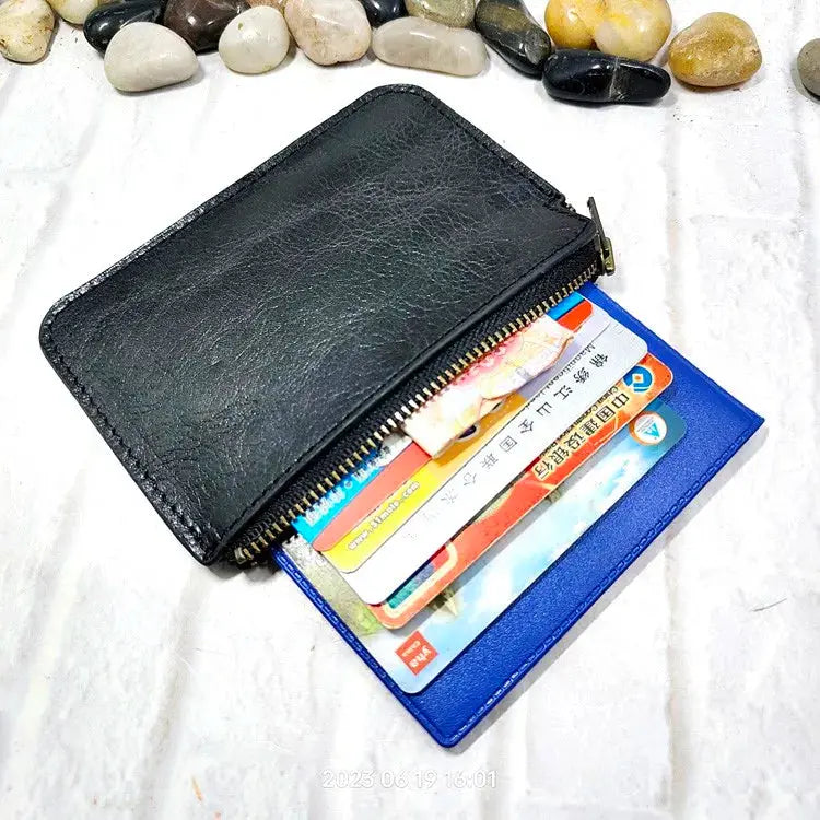 Mini zipper waist bag by Simples Market; black leather with card slots and blue cardholder visible.