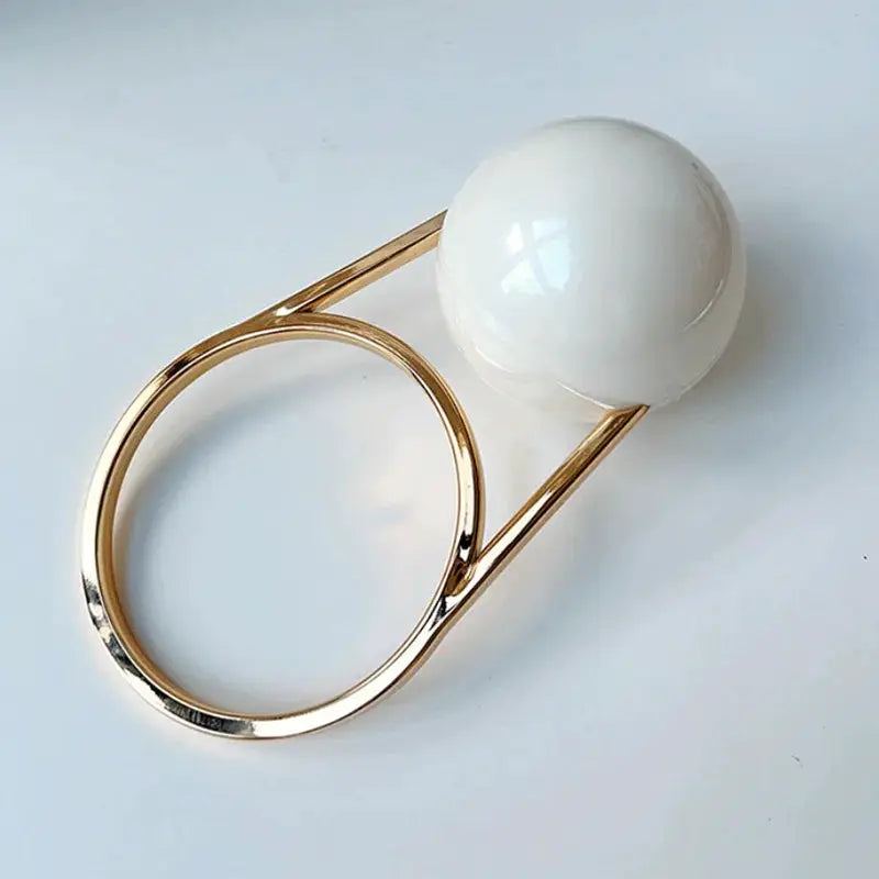 Ball-handle acrylic evening clutch with white ball and gold-tone ring frame