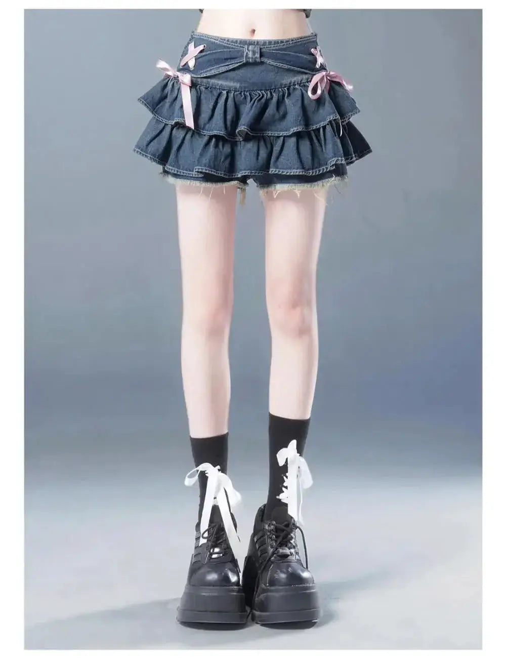Denim mini skirt with layered ruffles and pink bow accents; dark blue, by Simples Market.